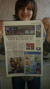 Dustin with a big newspaper article about him
